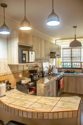 a kitchen with a table in the middle of it at Del Valle House in Ica