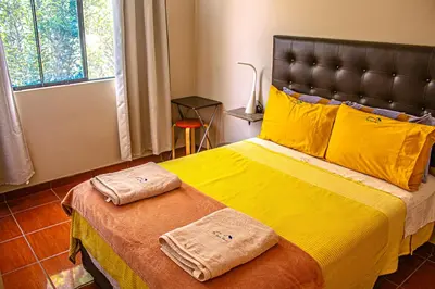 a bedroom with a large bed with two towels on it at Del Valle House in Ica