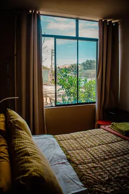 a bedroom with a bed and a large window at Del Valle House in Ica