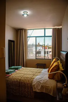 a bedroom with a bed and a large window at Del Valle House in Ica