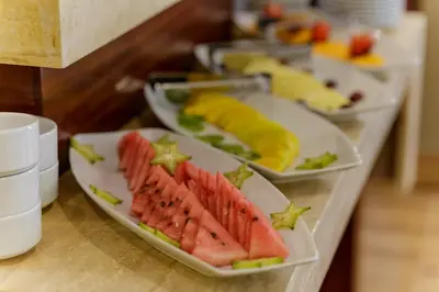 a buffet with plates of food on a table at Yawar Inka Hotel in Cusco