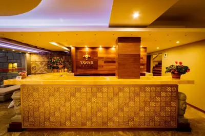 a lobby of a hotel with a reception counter at Yawar Inka Hotel in Cusco