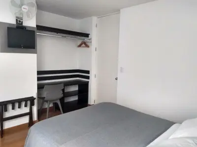 a bedroom with a bed and a desk in it at 3B Barranco by Katari Hoteles in Lima