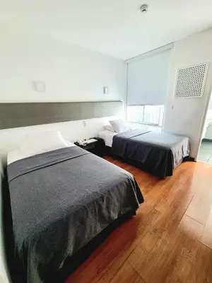 a bedroom with two beds and a window at 3B Barranco by Katari Hoteles in Lima