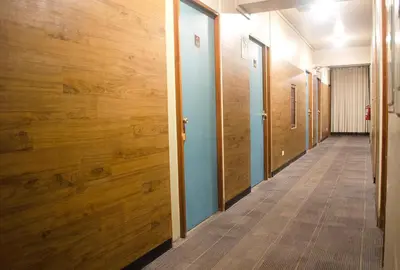 a hallway with wood paneled walls and a long corridor at Kamana Hotel in Lima