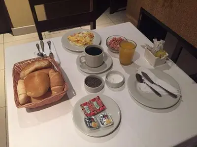 a table with plates of food on a table at Kamana Hotel in Lima