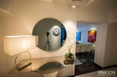 a room with a mirror and a table with chairs at Moon Luxury Apartments in Lima