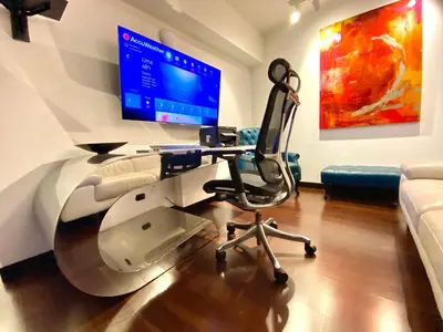 a dental office with a chair and a computer monitor at Moon Luxury Apartments in Lima