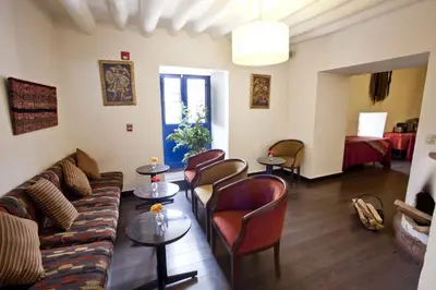 a living room with a couch and chairs and a table at Tierra Viva Cusco Saphi Hotel in Cusco