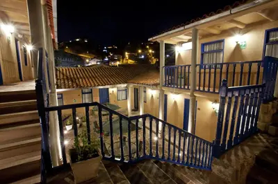 a balcony of a house at night with lights at Tierra Viva Cusco Saphi Hotel in Cusco