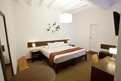 a hotel room with a bed and a table at Tierra Viva Cusco Saphi Hotel in Cusco