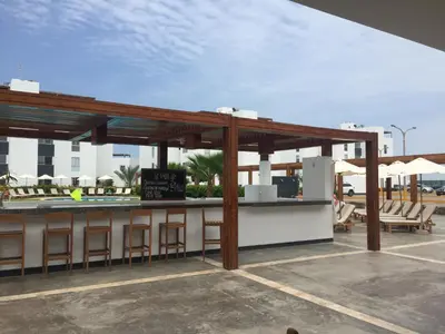 a bar with chairs and umbrellas on a patio at La Casa del Jota in Asia