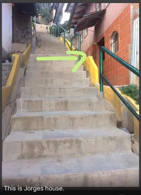 a green frisbee flying over a set of stairs at Wichana Wasi in Cusco