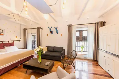 a bedroom with a bed and a couch and a table at X.O Art House in Cusco