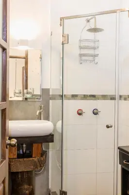 a bathroom with a sink and a shower at X.O Art House in Cusco
