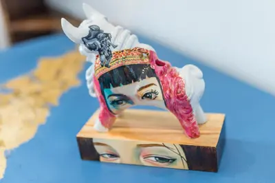 a toy figurine of a woman with a crown at X.O Art House in Cusco