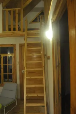 a staircase leading up to a loft in a room at San Alberto Ecolodge in Oxapampa