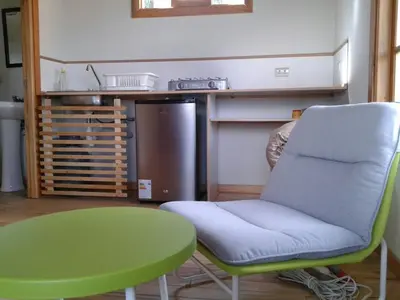 a room with a table and a chair and a green table at San Alberto Ecolodge in Oxapampa