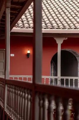 a building with a red wall with a light on it at Tambo del Arriero Hotel Boutique in Cusco