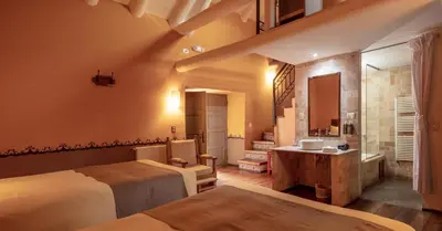 a bathroom with two beds and a sink in a room at Tambo del Arriero Hotel Boutique in Cusco