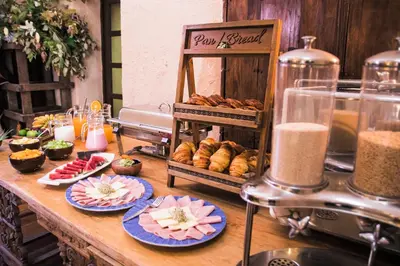 a table topped with plates of food and pastries at Tambo del Arriero Hotel Boutique in Cusco