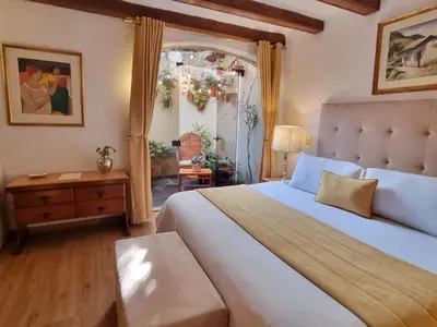 a bedroom with a large white bed and a table at Antara Hotel & Suites - Miraflores in Lima