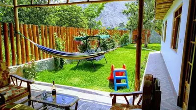 a hammock in the backyard of a house at Casa de Campo Belén - Lunahuaná in Lunahuaná