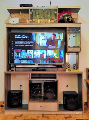 a entertainment center with a large television and speakers at Casa de Campo Belén - Lunahuaná in Lunahuaná