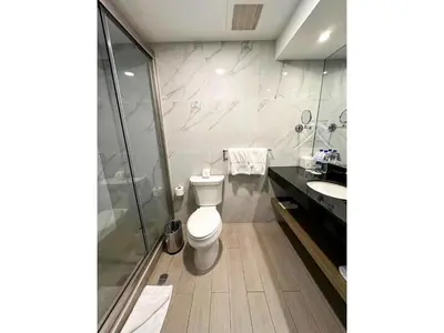 a bathroom with a toilet and a shower and a sink at Best Western Plus Urban Larco Hotel in Lima