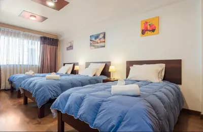 two beds in a room with blue sheets at Apartamento en el centro Cusco Inlove in Cusco