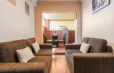 a living room with two couches and a table at Apartamento en el centro Cusco Inlove in Cusco