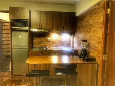 a kitchen with a wooden counter and a refrigerator at Excelente ubicación en el Centro Cusco Inlove in Cusco