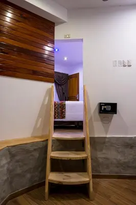 a room with a ladder leading to a bedroom at El Encanto in Lunahuaná