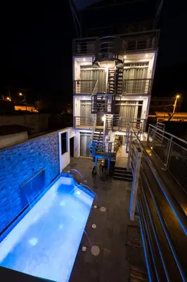 a building with a swimming pool at night at El Encanto in Lunahuaná