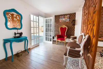 a living room with a blue table and chairs at El Encanto in Lunahuaná