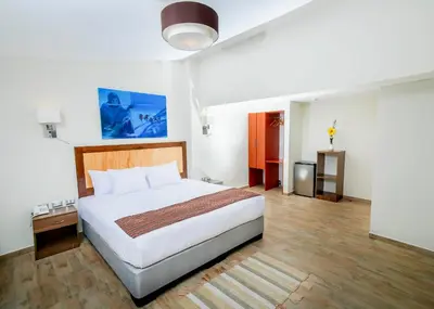 a bedroom with a large bed in a room at Golden Sunrise Machupicchu in Machu Picchu