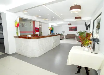 a lobby with a reception counter and a table at Golden Sunrise Machupicchu in Machu Picchu