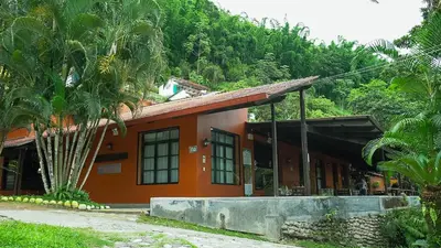 a building with a palm tree in front of it at Fundo San Jose Parque Ecológico & Lodge Hotel Asociado Casa Andina in La Merced