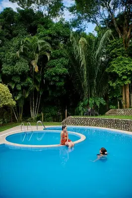 a couple of people sitting in a swimming pool at Fundo San Jose Parque Ecológico & Lodge Hotel Asociado Casa Andina in La Merced