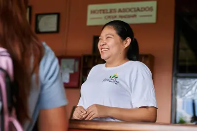 a woman standing in front of a counter at Fundo San Jose Parque Ecológico & Lodge Hotel Asociado Casa Andina in La Merced