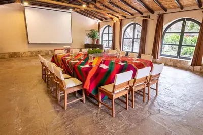 a large room with a long table and chairs at Sonesta Posadas del Inca - Valle Sagrado Yucay Urubamba in Urubamba