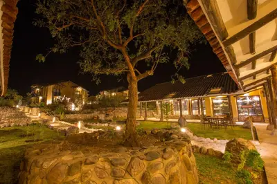 a tree in front of a building at night at Tierra Viva Valle Sagrado Hotel in Urubamba