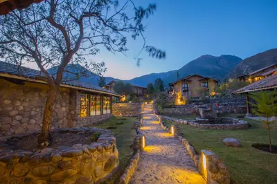 a stone path in front of a house at night at Tierra Viva Valle Sagrado Hotel in Urubamba