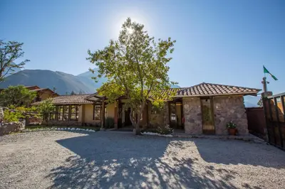 a house with a tree in the driveway at Tierra Viva Valle Sagrado Hotel in Urubamba