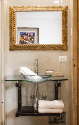 a bathroom with a sink and a mirror at Waman Qorikancha in Cusco