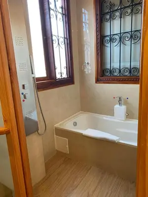 a bathroom with a bath tub and a window at Waman Qorikancha in Cusco
