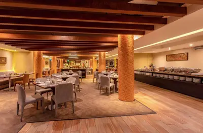 a restaurant with tables and chairs and a bar at Sonesta Hotel Cusco in Cusco