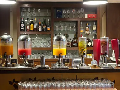 a bar with a bunch of different types of drinks at Sonesta Hotel Cusco in Cusco