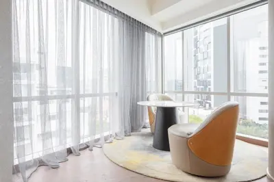 a room with a large window with a table and chairs at JW Marriott Hotel Lima in Lima