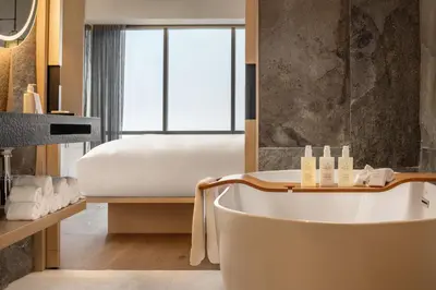 a bathroom with a tub and a bed at JW Marriott Hotel Lima in Lima